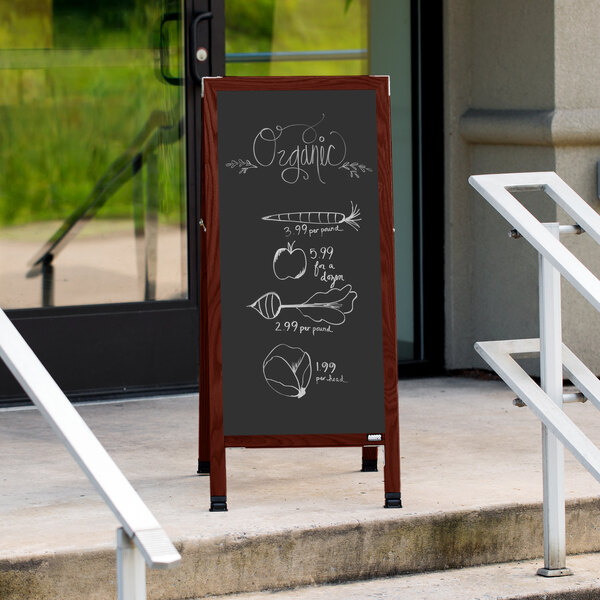 A cherry A-Frame sign board with a black chalkboard displaying a menu on a sidewalk.