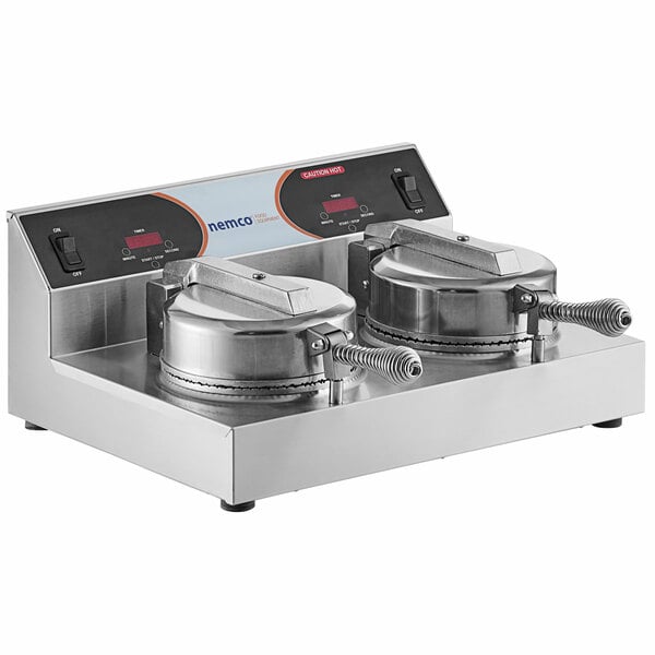 A Nemco double grid waffle cone maker on a counter in a professional kitchen.