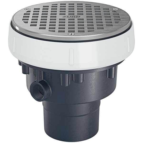A Zurn floor drain with a round nickel bronze lid over a circular grey and white PVC drain.