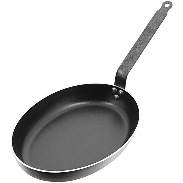 A black de Buyer oval frying pan with a silver rim and a metal handle.