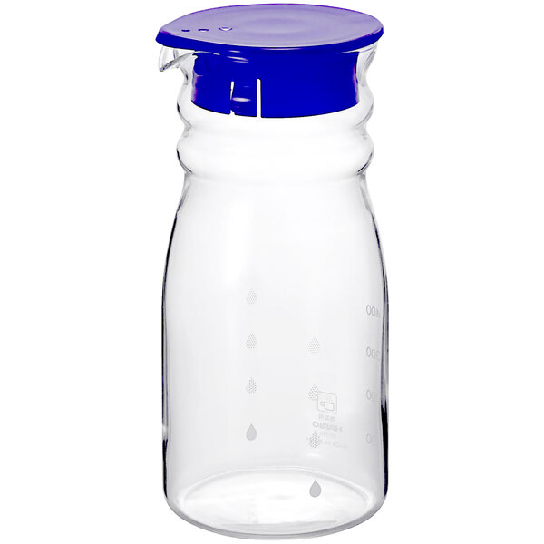 A clear glass bottle with a navy blue lid.