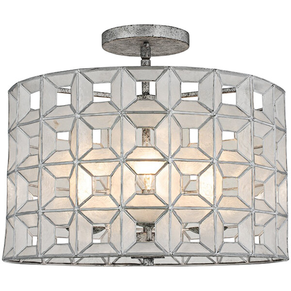 A Kalco Prado semi-flush mount light with a round white shade and geometric shapes.