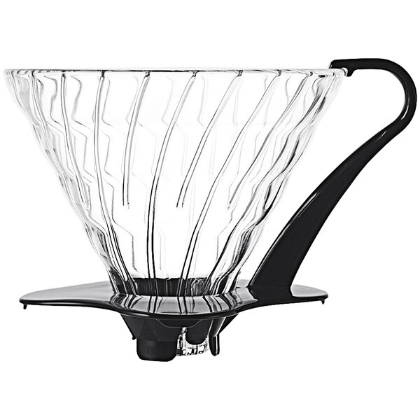 A clear glass coffee dripper with a black base.