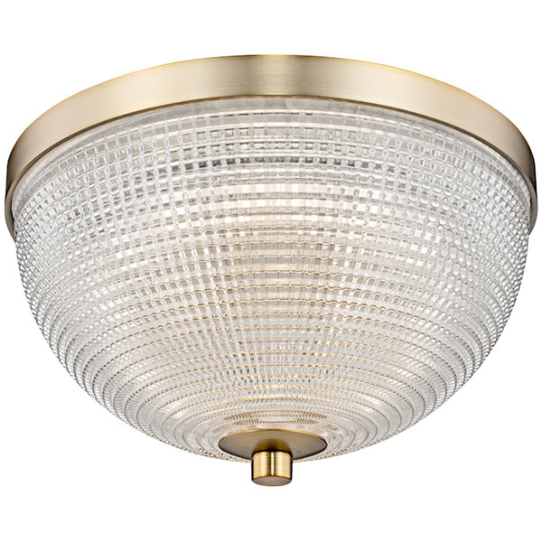 A Kalco Portland LED flush mount light with a glass dome and brass finish.