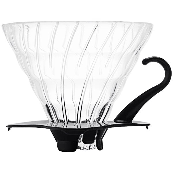 A Hario V60 glass coffee dripper with a black handle.
