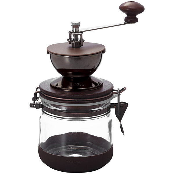 A Hario coffee grinder with a metal handle.