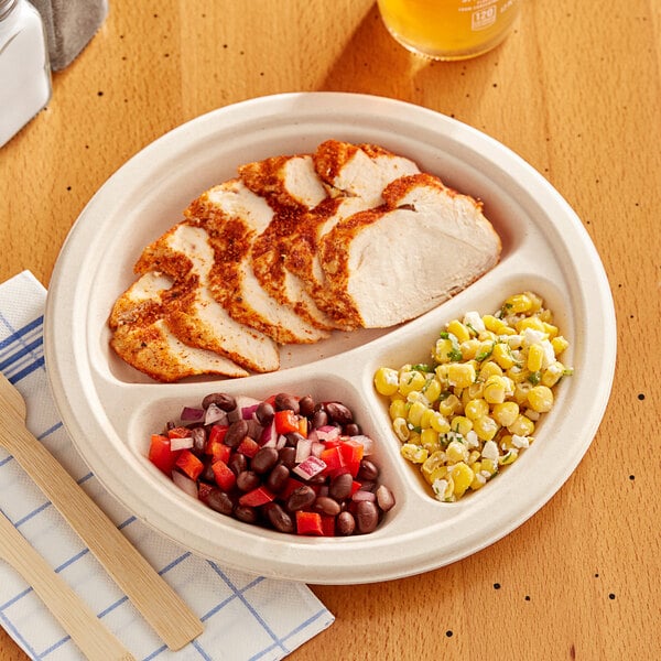 A EcoChoice bagasse plate with meat and corn on it.