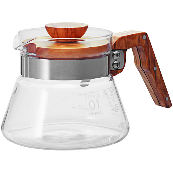A Hario glass coffee server with a wooden handle.