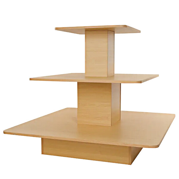 A wooden Econoco three-tier display table with a square base.