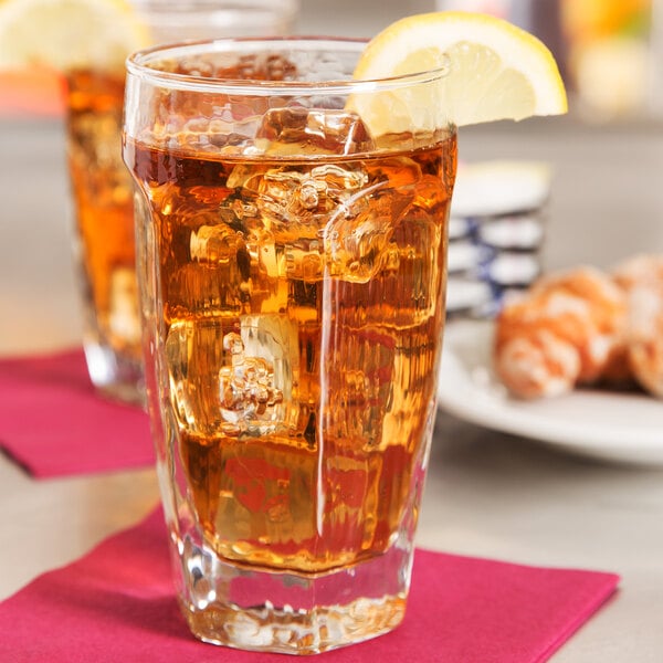 Two Libbey Chivalry beverage glasses filled with iced tea and lemon slices.