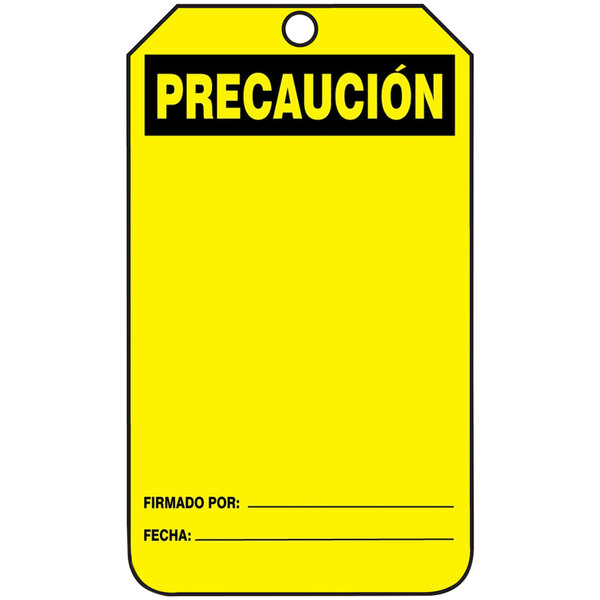 A white Accuform plastic equipment tag with yellow and black text that reads "Precaucion"