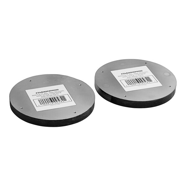 A pair of round metal discs with barcode labels.
