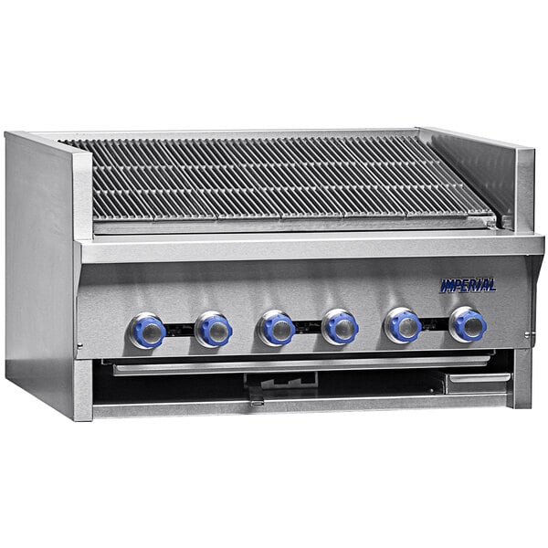 A close-up of an Imperial Range natural gas steakhouse broiler with blue knobs and a stainless steel handle.