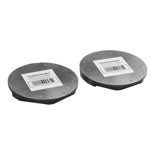 A pair of round metal discs with bar code labels.