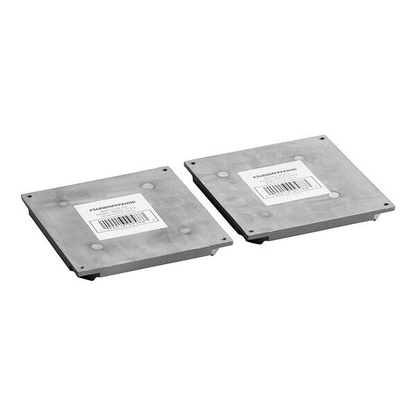 A pair of metal plates with labels for Estella Panini Plate.