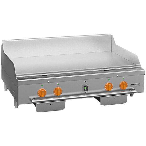 A Wood Stone stainless steel liquid propane griddle with orange knobs on a metal surface.