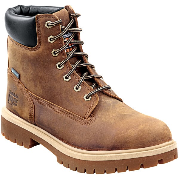A pair of Timberland PRO Earth Bandit brown leather steel toe boots with black laces.