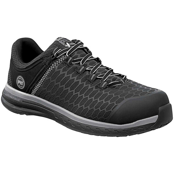 A black Timberland PRO athletic shoe with laces and a composite toe.