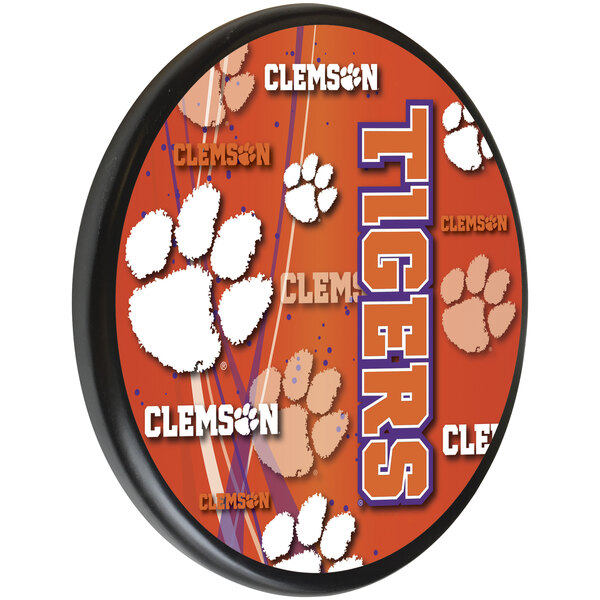 A orange wooden sign with the Clemson University logo in white and purple.
