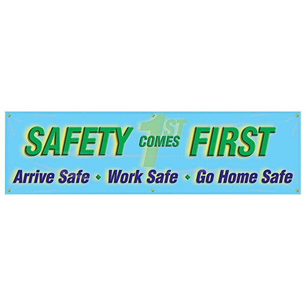 A blue sign with green and blue text reading "Safety Comes First / Arrive Safe, Work Safe, Go Home Safe"