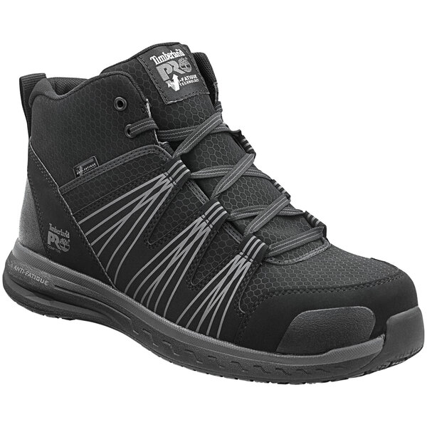 A black Timberland PRO hiker boot with grey accents and composite toe.