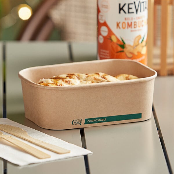 A rectangular EcoChoice paper take-out container holding food on a table.