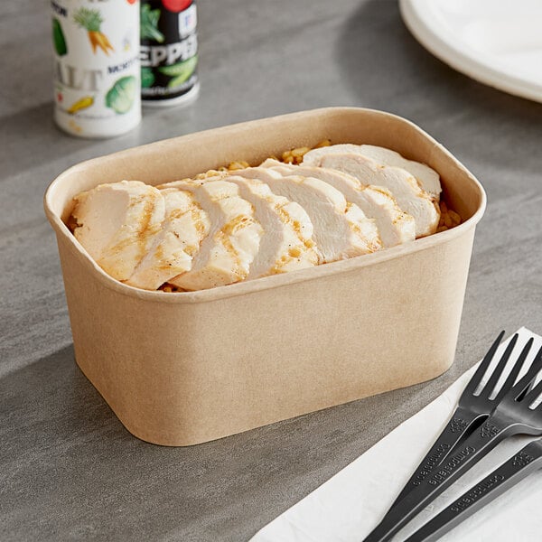 A Choice rectangular Kraft paper take-out container with chicken and vegetables inside.