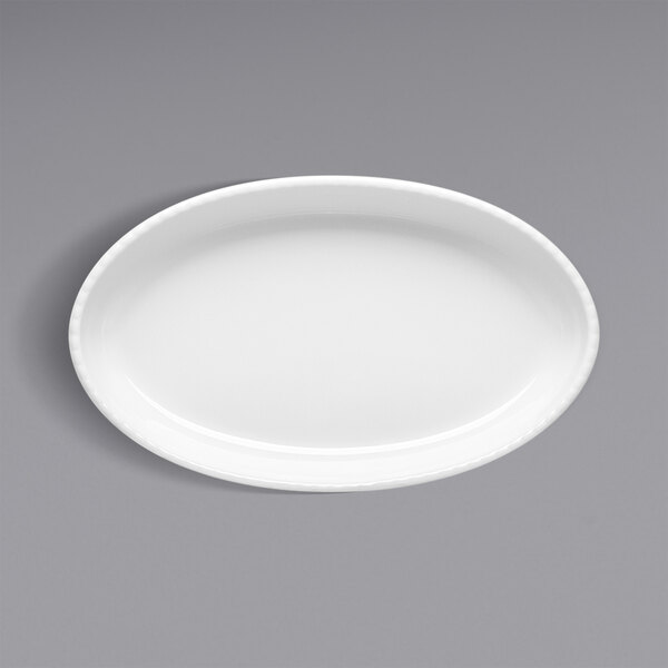 A white oval porcelain souffle dish on a white background.