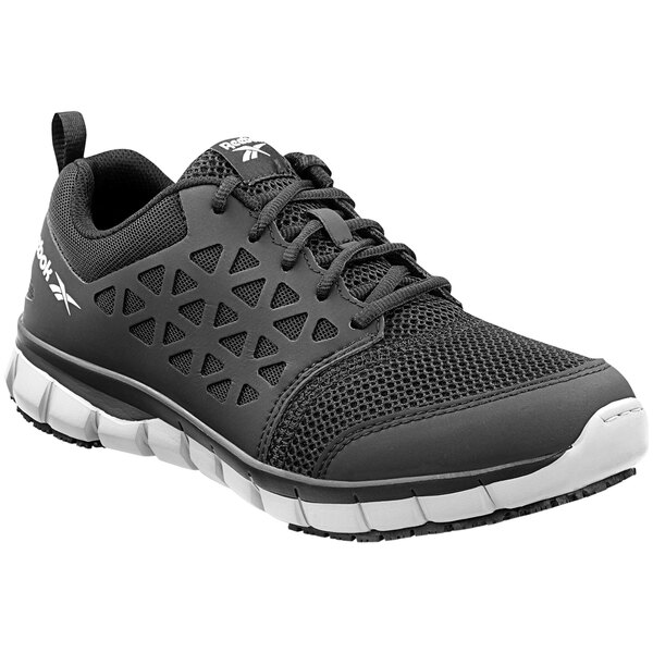 A black Reebok athletic shoe with a white sole and mesh.