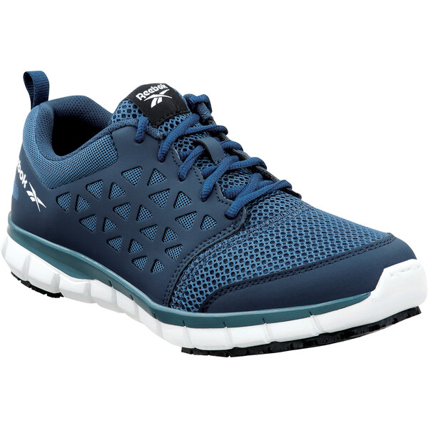 A close up of a Reebok Work Sublite men's navy blue athletic shoe with white accents.