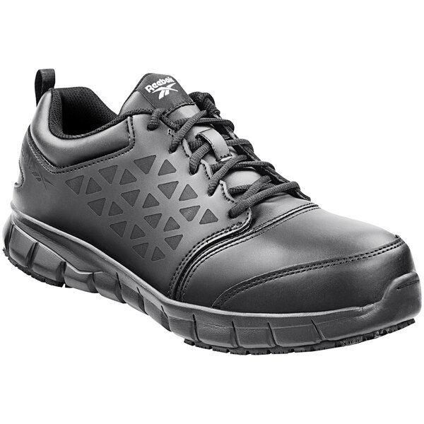 A pair of black Reebok Work athletic shoes with a lace-up design.