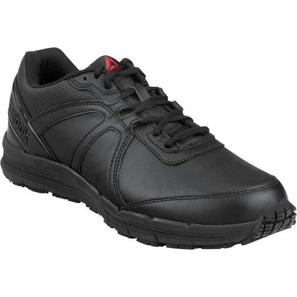 A black Reebok men's safety shoe with a red logo.