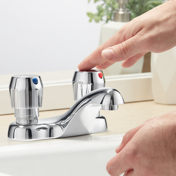 A person using a Chicago Faucets metering faucet to wash their hands.