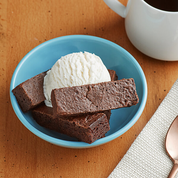 A brownie with a scoop of ice cream on a plate.