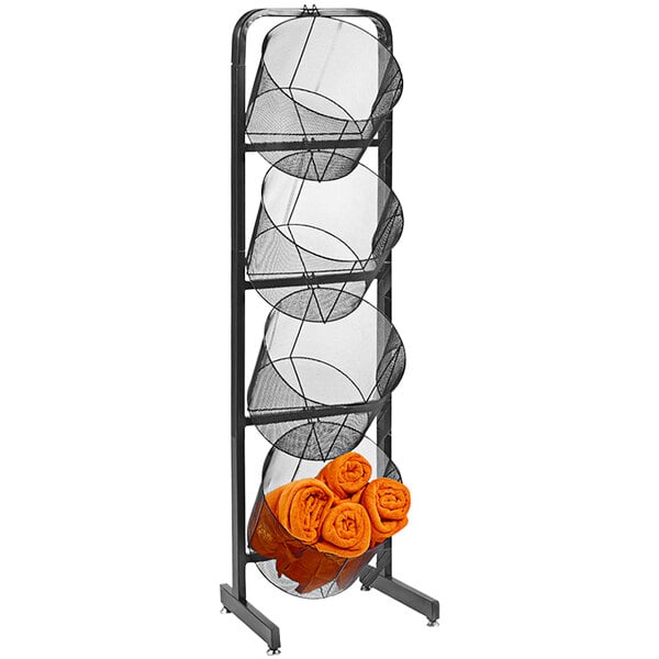 A black wire grid display rack with 4 round baskets, one filled with orange towels.
