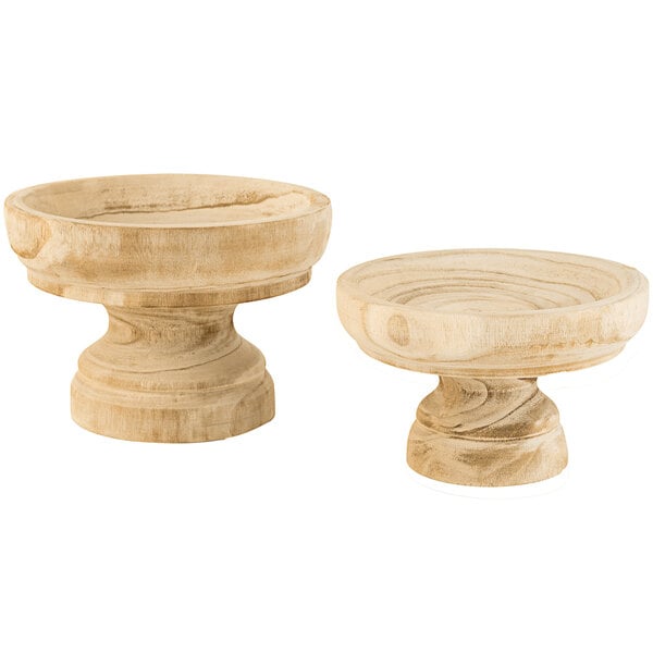 A pair of wooden bowls on a wooden base.