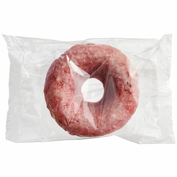 An individually wrapped Southern Roots vegan red velvet cake donut in a plastic bag.