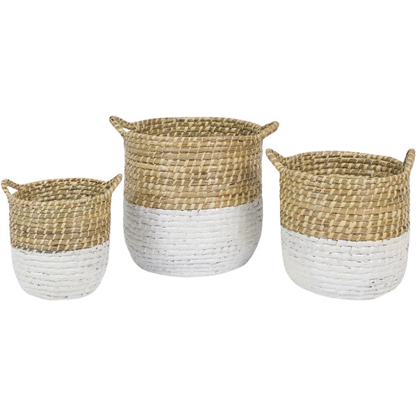 A group of three white woven seagrass baskets with handles.