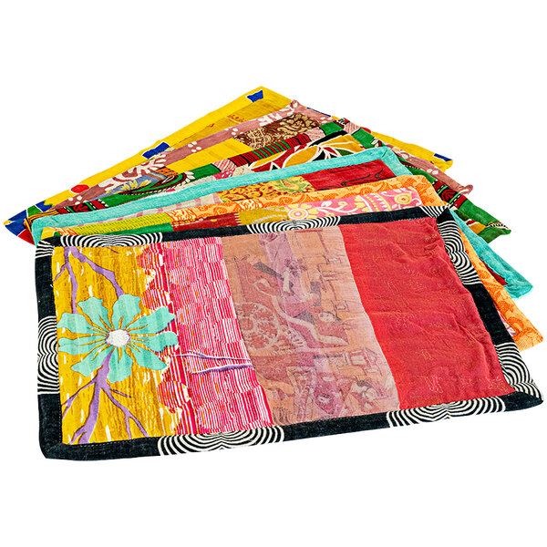 A stack of colorful cloth Kalalou knit placemats with different designs.