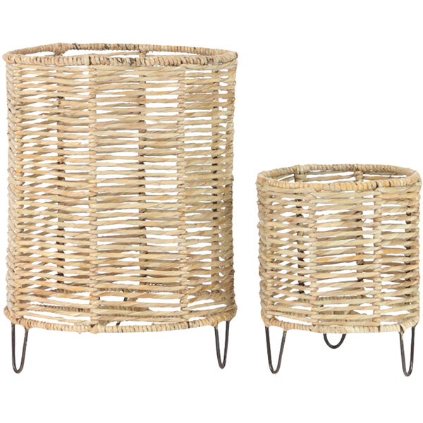 A pair of wicker baskets with metal legs.