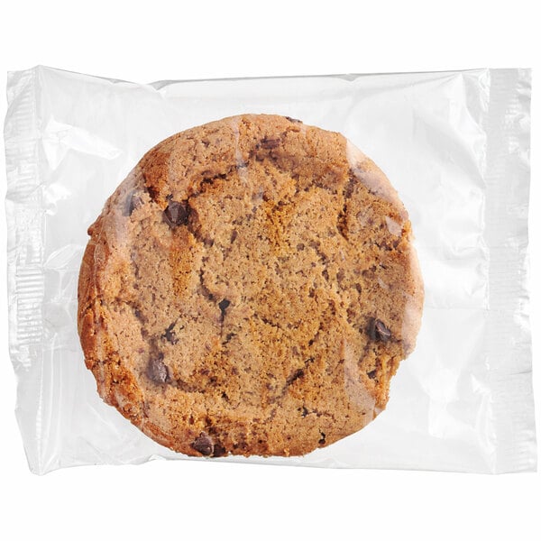 An individually wrapped Southern Roots vegan chocolate chip cookie in a plastic bag.
