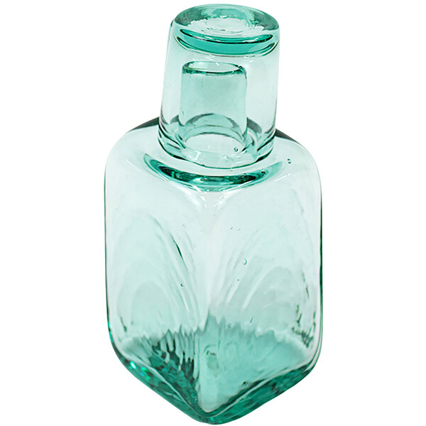 A clear glass Kalalou carafe with a square top.