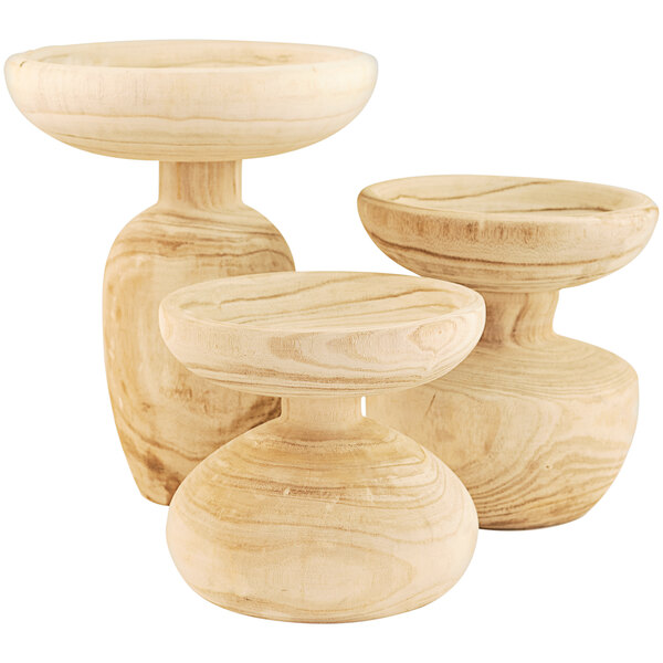 A group of wooden bowls with round bases sitting on top of each other.