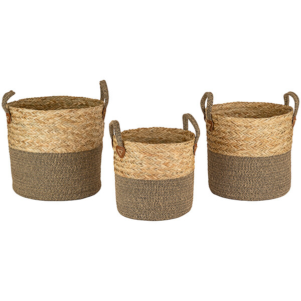 A group of three Kalalou two-tone woven seagrass baskets with handles.