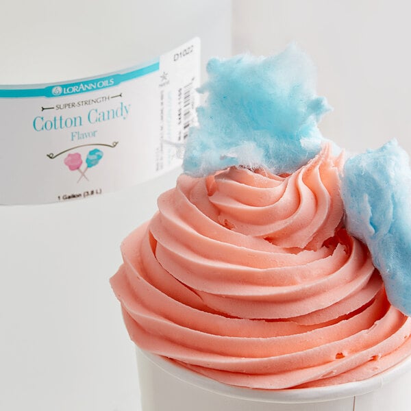 A cup of cotton candy with pink and blue swirls.