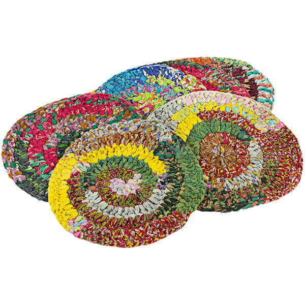A close-up of a group of multicolor round Kalalou knit placemats with different designs.