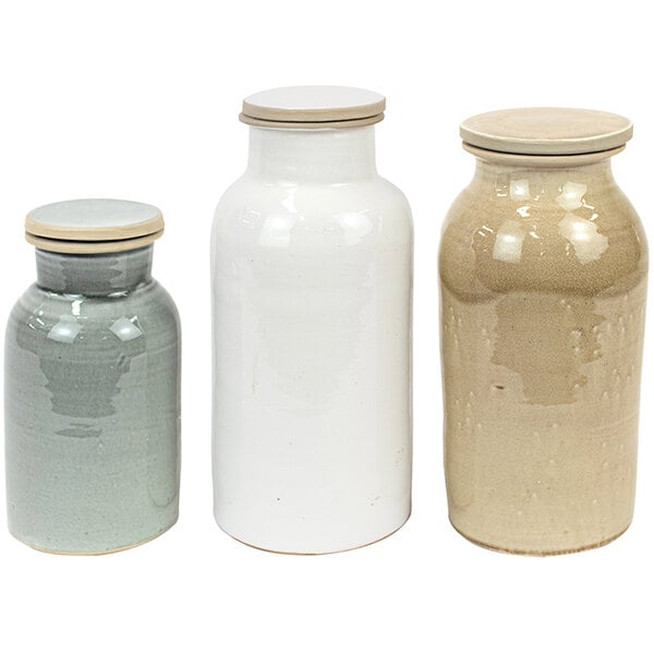 A group of multicolor ceramic jars with lids.
