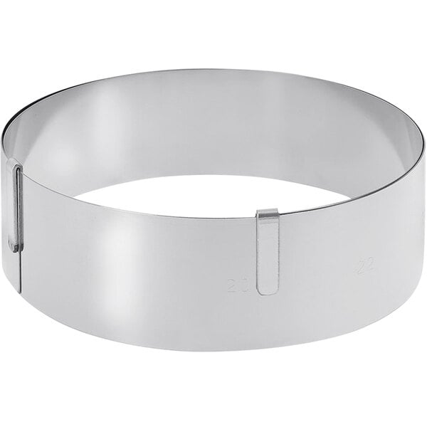 A silver circular de Buyer stainless steel pastry ring with a handle.