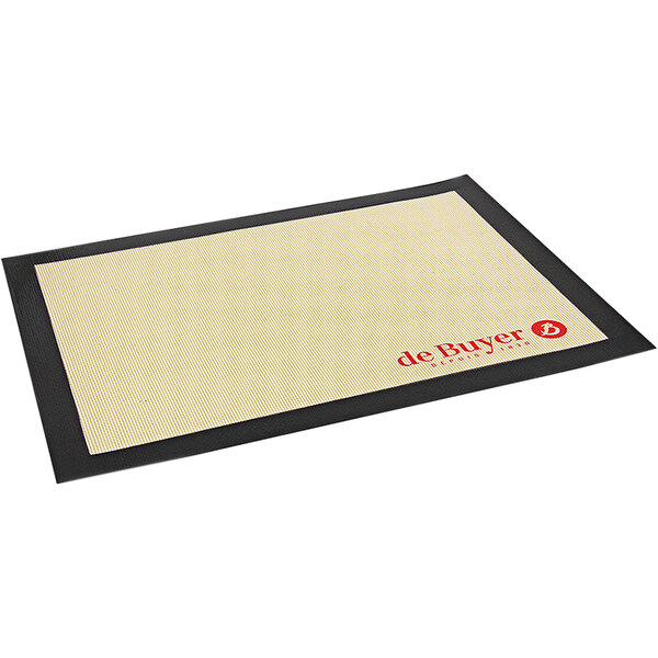 A black and tan de Buyer silicone baking mat with red text and logos.