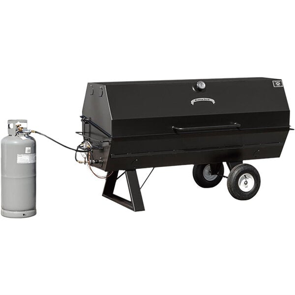 A black Meadow Creek charcoal pig roaster on wheels with a grey cylinder attached.